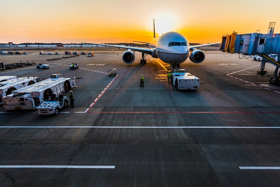 Kuala Lumpur International Airport terminal with planes parked at sunset